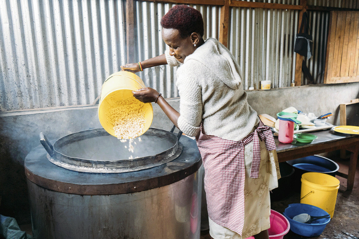 Empowering education through sustainability_Woman cooking lunch for pupils using DGB’s cookstove_visual 2