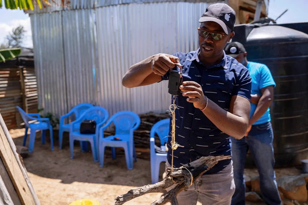 Ensuring impact, Kitchen performance testing for DGBs cookstoves_A DGB team member weighing firewood_visual 4