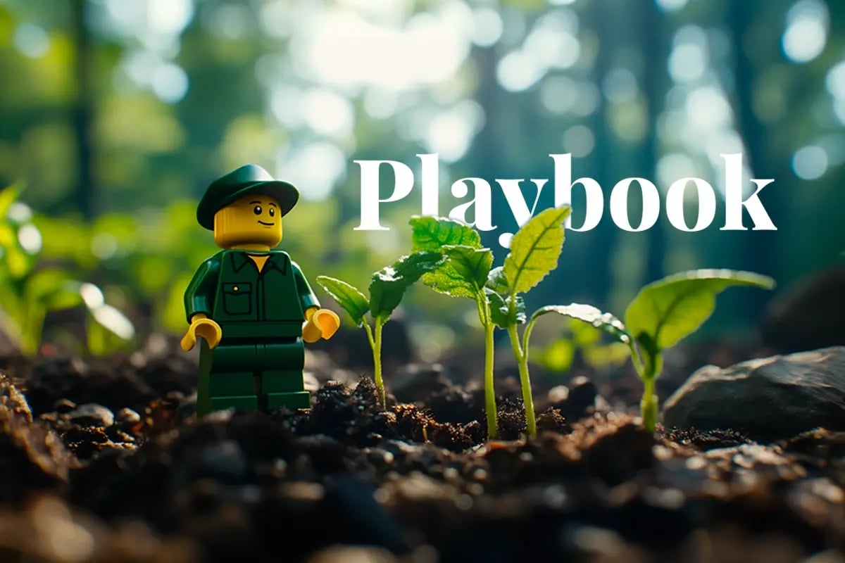 Lego commits $2 6m to carbon removal projects_A close-up shot of a small Lego figurine dressed as a forester, standing among young tree seedlings in a forest_visual 1