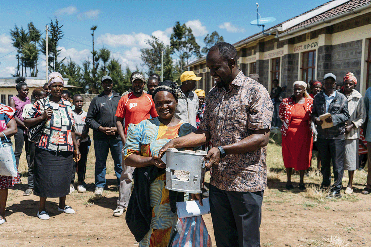 The power of high-quality carbon projects_DGB team member and local community during cookstove distribution_visual 4