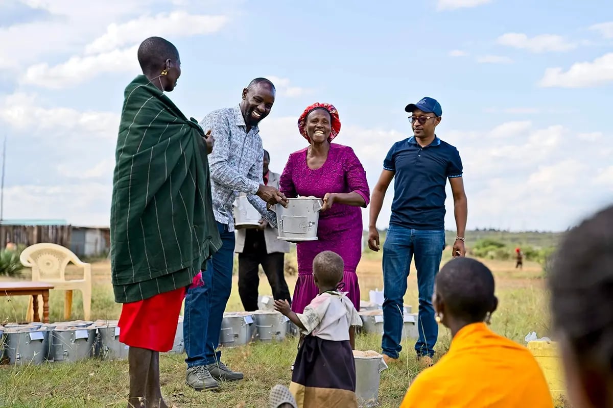 Understanding carbon footprints_ impact, benefits, and reporting_A DGB team member and local community during the distribution of cookstoves in Kenya_visual 7