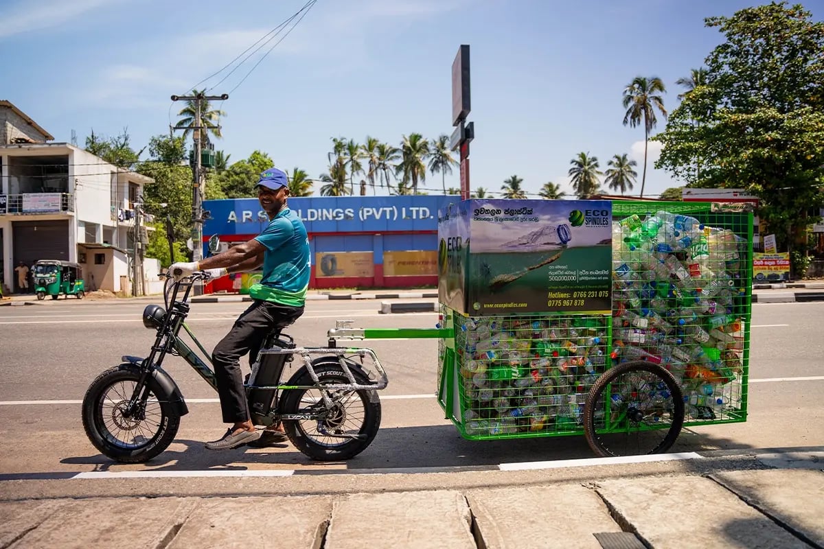 Unlock a green future through sustainable impact investing_DGB team member using an electric bike for plastic waste collection_visual 2