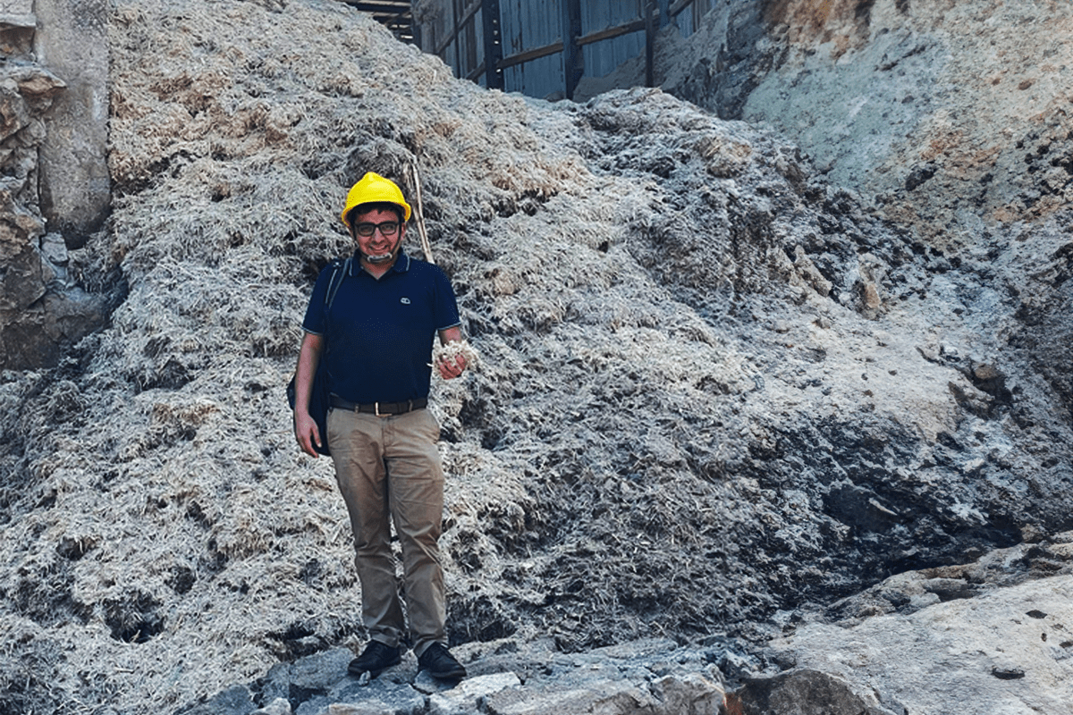 new innovative carbon storage solution_Dr Anubhav Mohiley in front of a pile of sugar cane waste_Visual 3